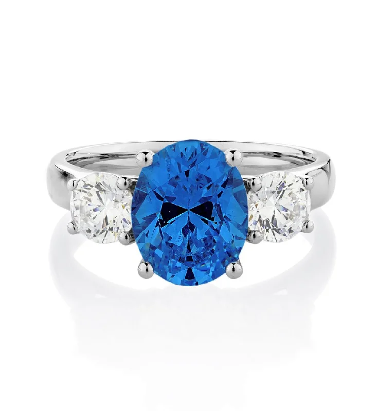 unique rings for women -Three stone ring with 10x8mm ceylon sapphire simulant and 0.92 carats* of diamond simulants in 10 carat white gold