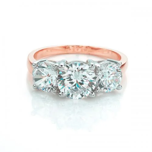 fashion statement rings -Three stone ring with 3 carats* of diamond simulants in 10 carat rose and white gold