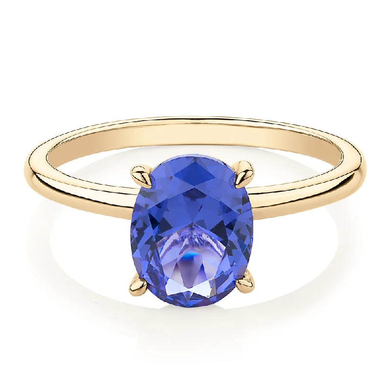 geometric rings for women -Dress ring with tanzanite simulant in 10 carat yellow gold