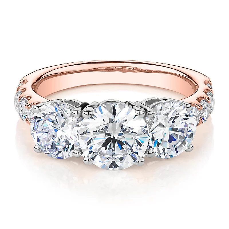 classic engagement rings -Three stone ring with 3.44 carats* of diamond simulants in 10 carat rose and white gold